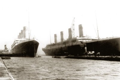 RMS Titanic being moved out of drydock to allow her sister ship, RMS Olympic, to have a propeller replaced, March 6, 1912 by English Photographer